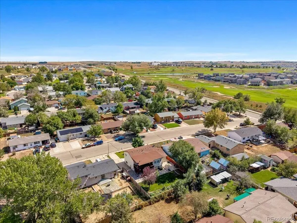 an aerial view of residential houses with outdoor space