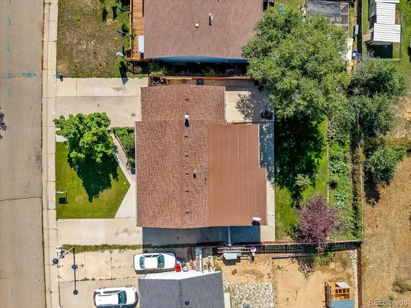 an aerial view of a house with a yard
