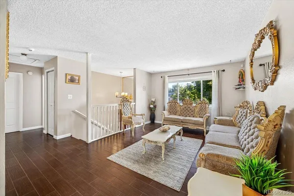 a living room with furniture and wooden floor