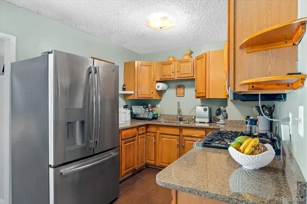 a kitchen with stainless steel appliances and a refrigerator
