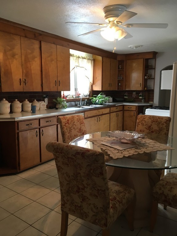 119 Fargo Street Springfield, MA 01119 - Photo 8 of 23 a kitchen with stainless steel appliances granite countertop a stove a sink and a microwave