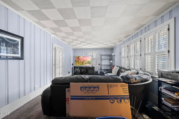 a living room with furniture a window and a flat screen tv