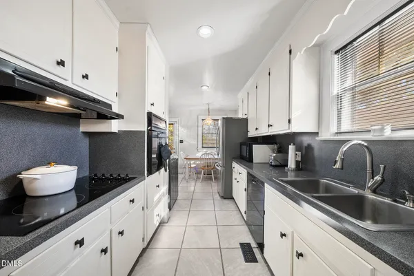 a kitchen with a sink and a stove top oven