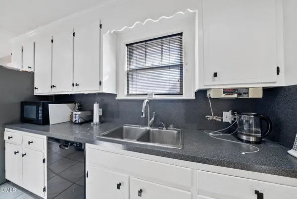 a kitchen with cabinets appliances and a sink