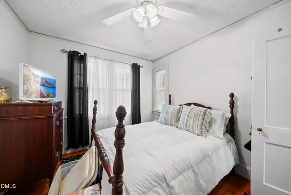 a bedroom with a bed and a chandelier