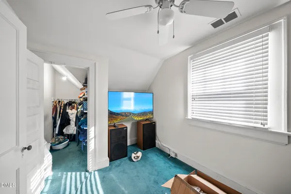 a view of a livingroom with a window and a ceiling fan