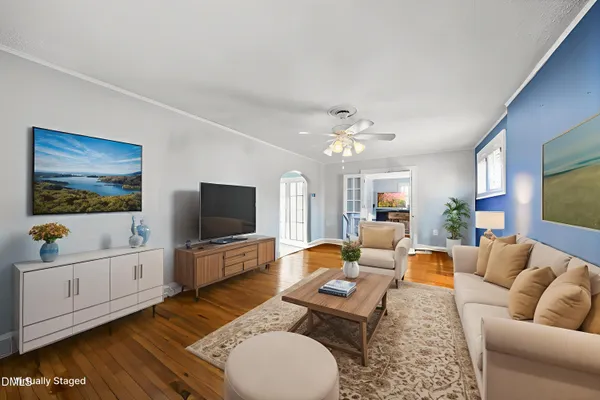 a living room with furniture and a flat screen tv