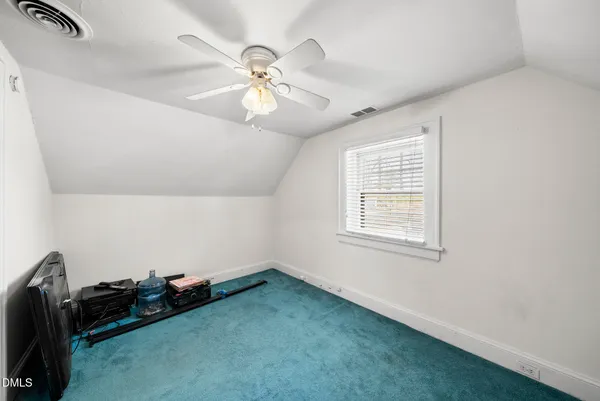 a room with a window and a fan