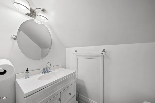 a bathroom with a sink vanity and mirror