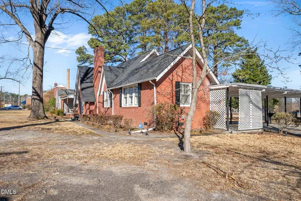 a view of a house with a tree in the background