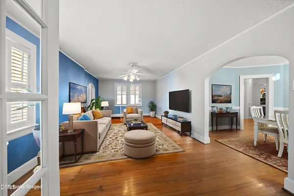 a living room with furniture and a flat screen tv