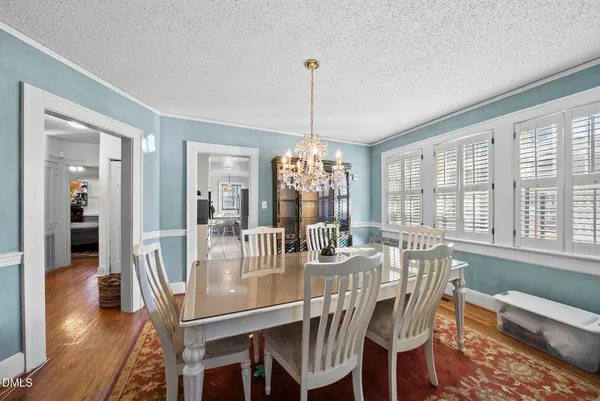 a dining room with furniture window and wooden floor