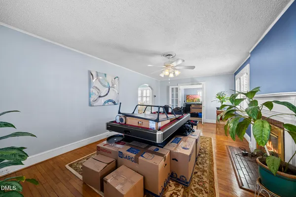 a living room with furniture and a chandelier