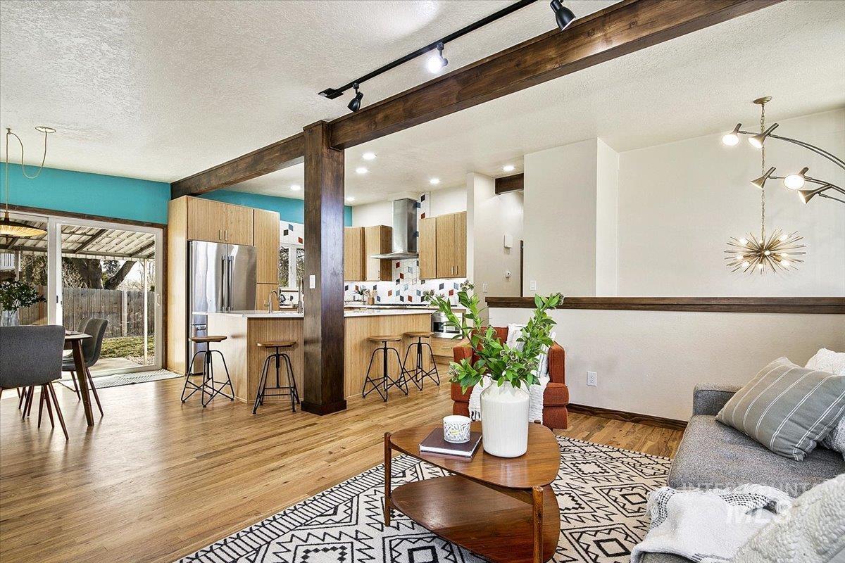 2518 Lancaster Drive Boise, ID 83702 - Photo 19 of 41 Living room with light wood-type flooring, a textured ceiling, rail lighting, and beamed ceiling