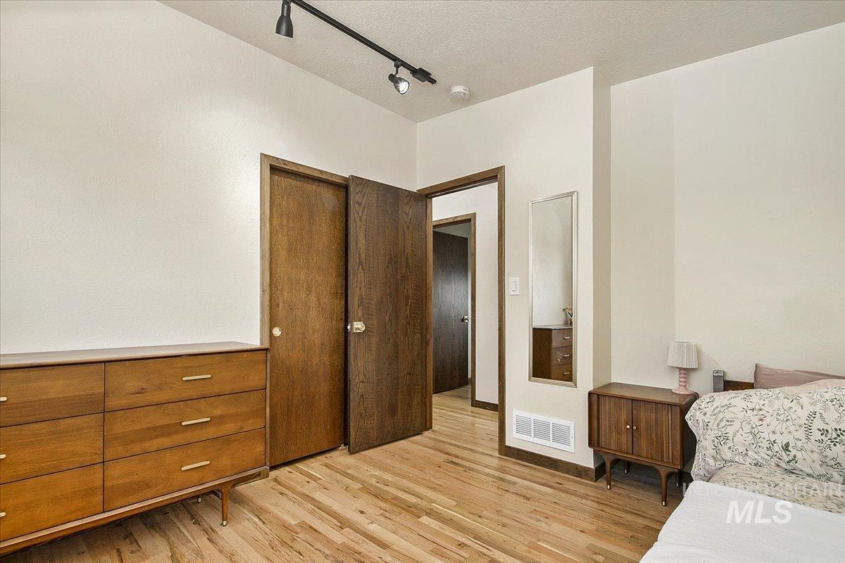 2518 Lancaster Drive Boise, ID 83702 - Photo 29 of 41 Bedroom with rail lighting, light wood-type flooring, and a textured ceiling