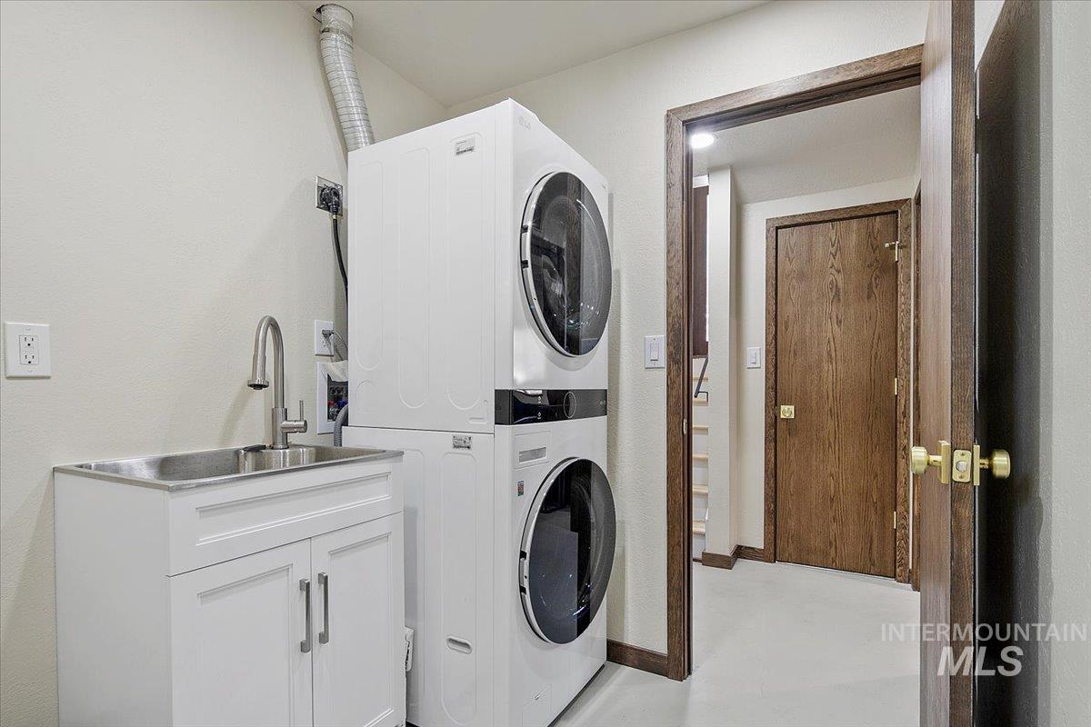 2518 Lancaster Drive Boise, ID 83702 - Photo 36 of 41 Laundry room with stacked washer / drying machine, cabinet space, and concrete floors