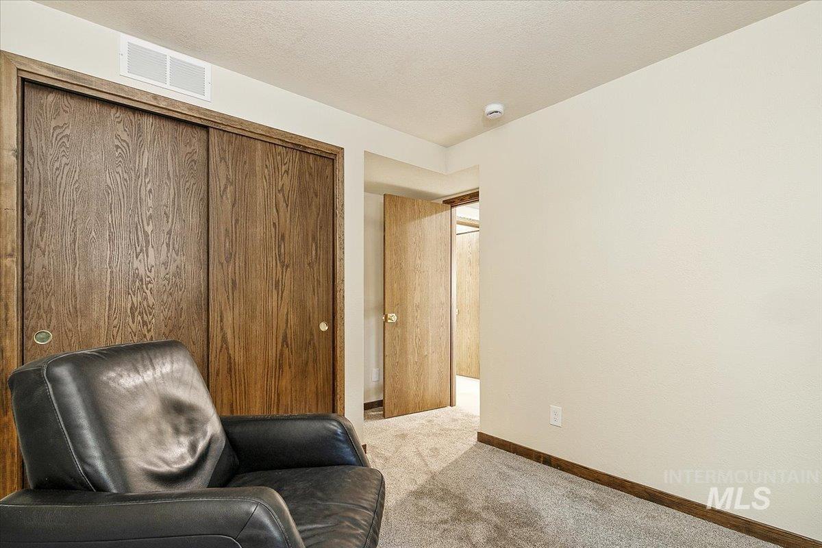 2518 Lancaster Drive Boise, ID 83702 - Photo 38 of 41 Living area featuring light colored carpet and a textured ceiling