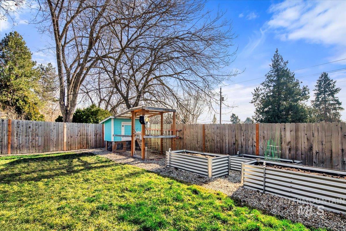 2518 Lancaster Drive Boise, ID 83702 - Photo 41 of 41 Fenced backyard with a garden, an outbuilding, and exterior structure
