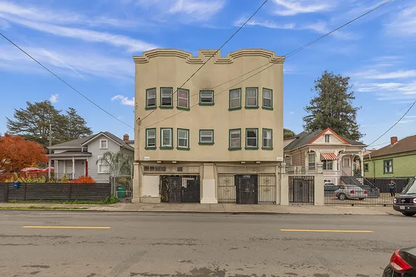 a front view of a residential apartment building with a yard