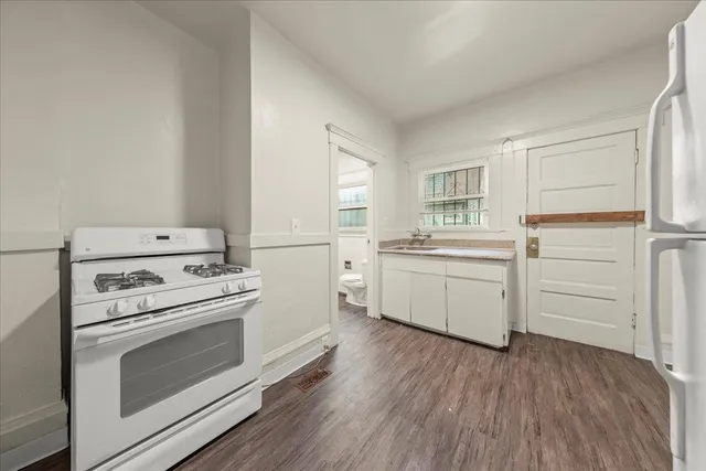 a kitchen with a stove oven and sink