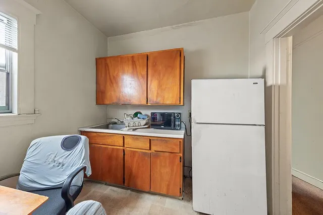 a white refrigerator freezer sitting inside of a kitchen