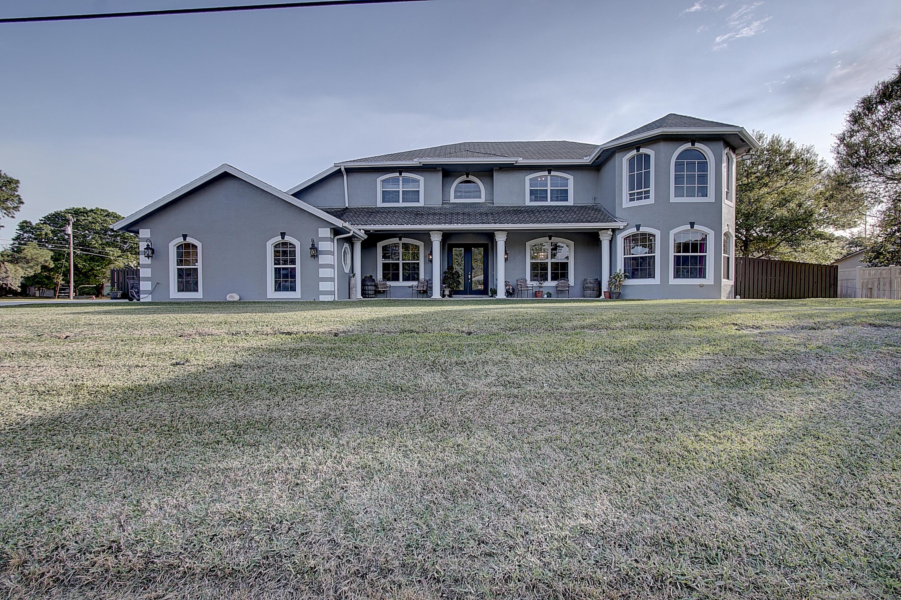 a big house with a big yard and large trees
