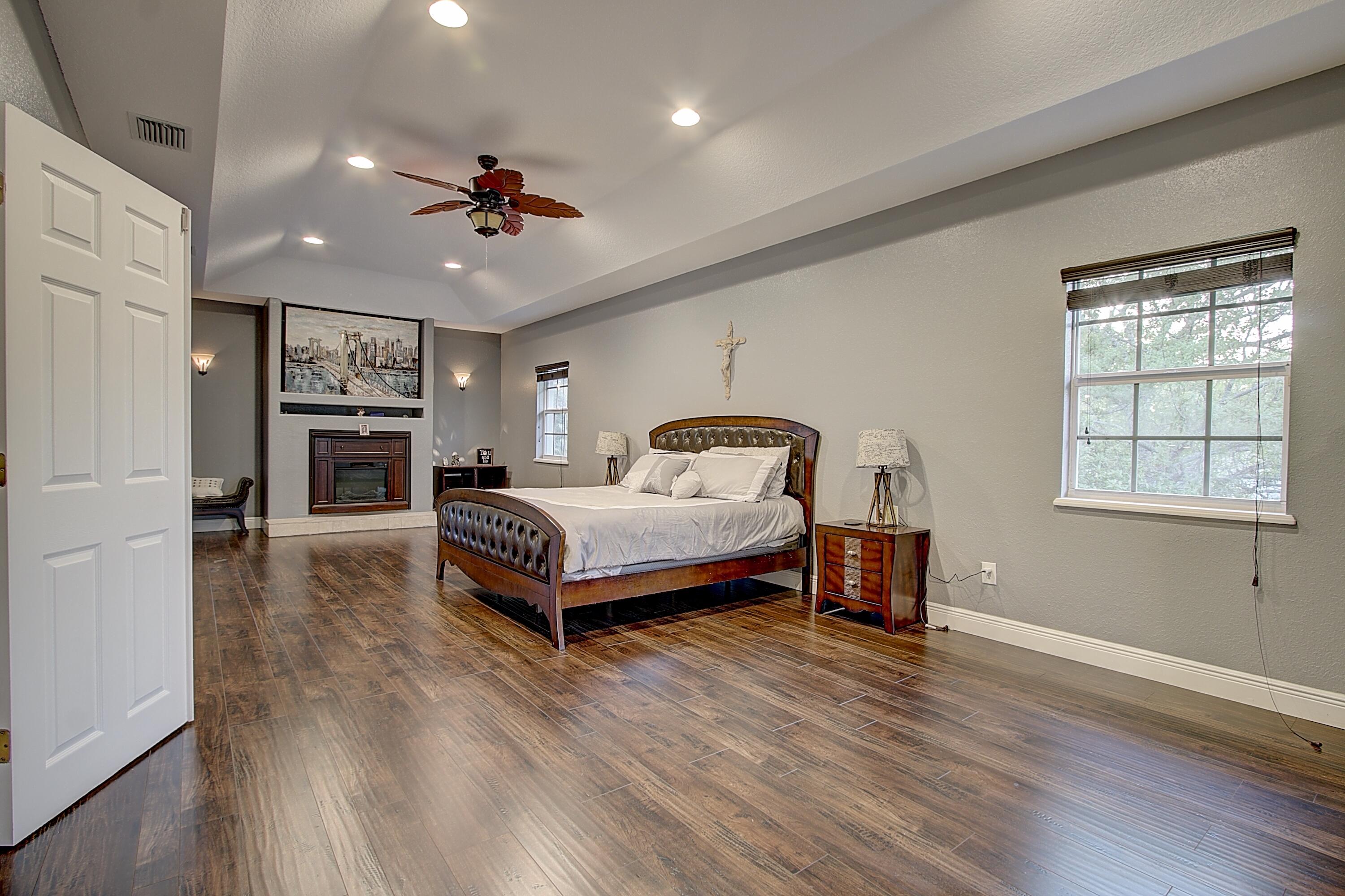 669 Howard Street Fort Pierce, FL 34982 - Photo 11 of 15 a bedroom with a bed wooden floor and chandelier