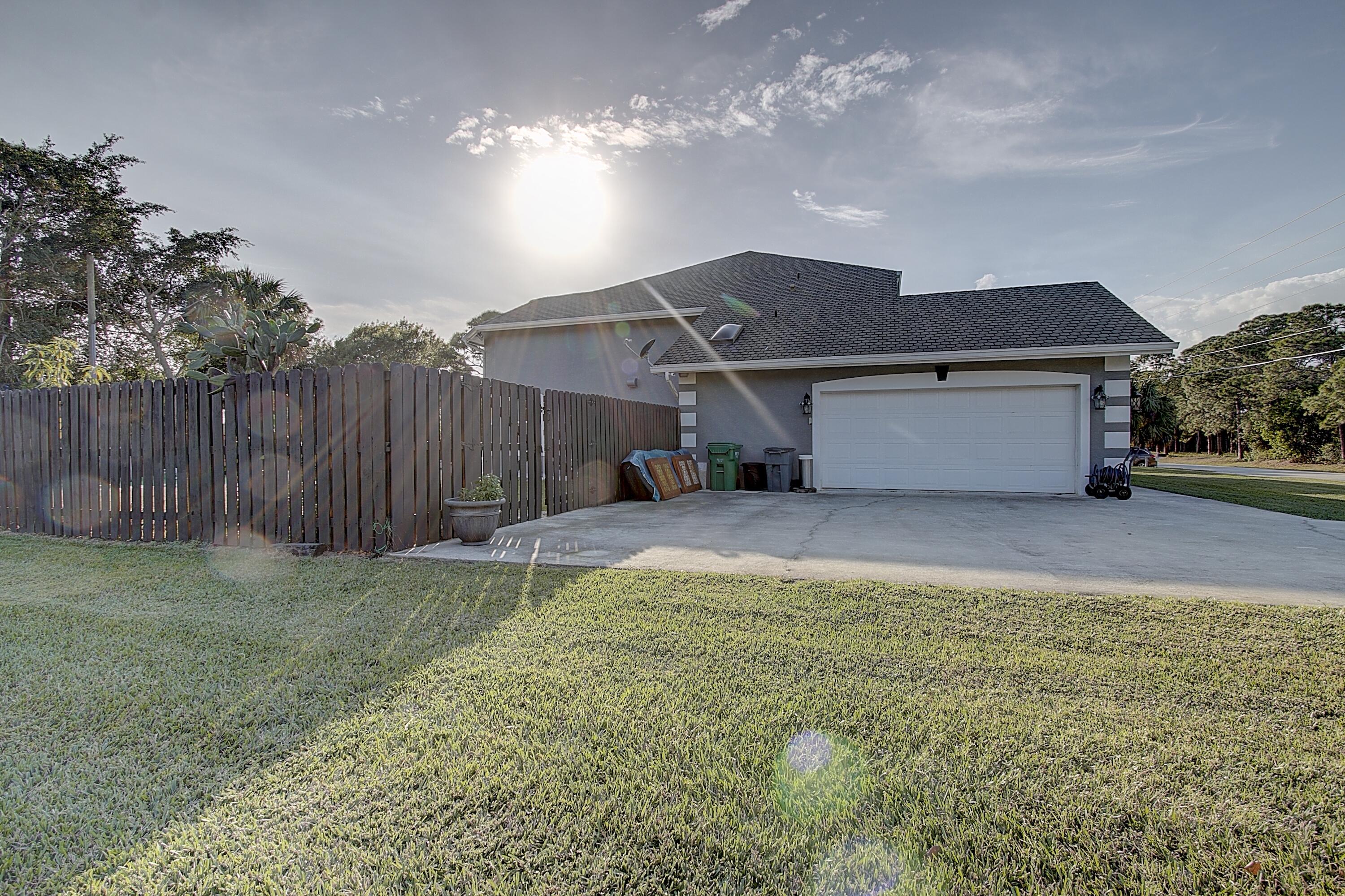 669 Howard Street Fort Pierce, FL 34982 - Photo 3 of 15 a view of a house with a yard and garage