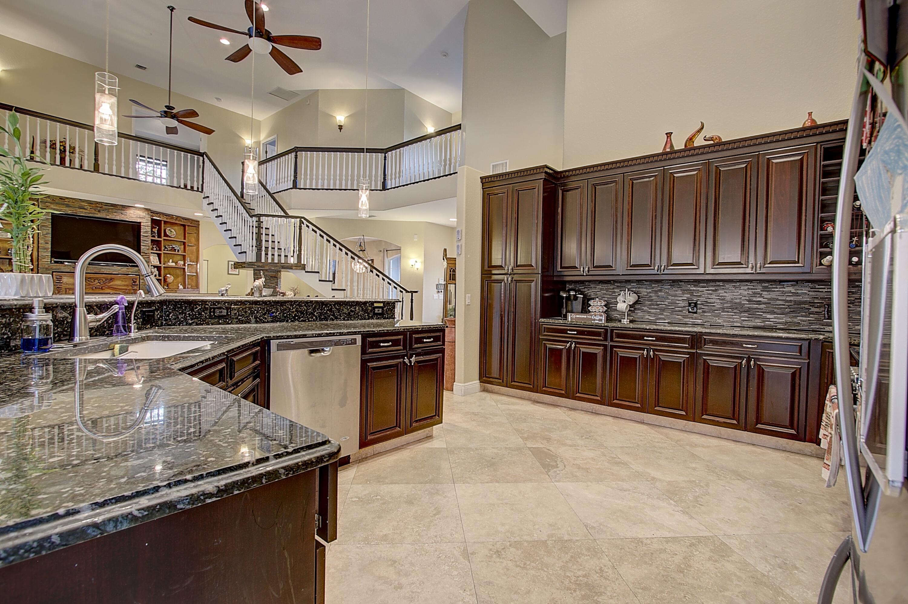 669 Howard Street Fort Pierce, FL 34982 - Photo 8 of 15 a kitchen with kitchen island a sink stove and refrigerator