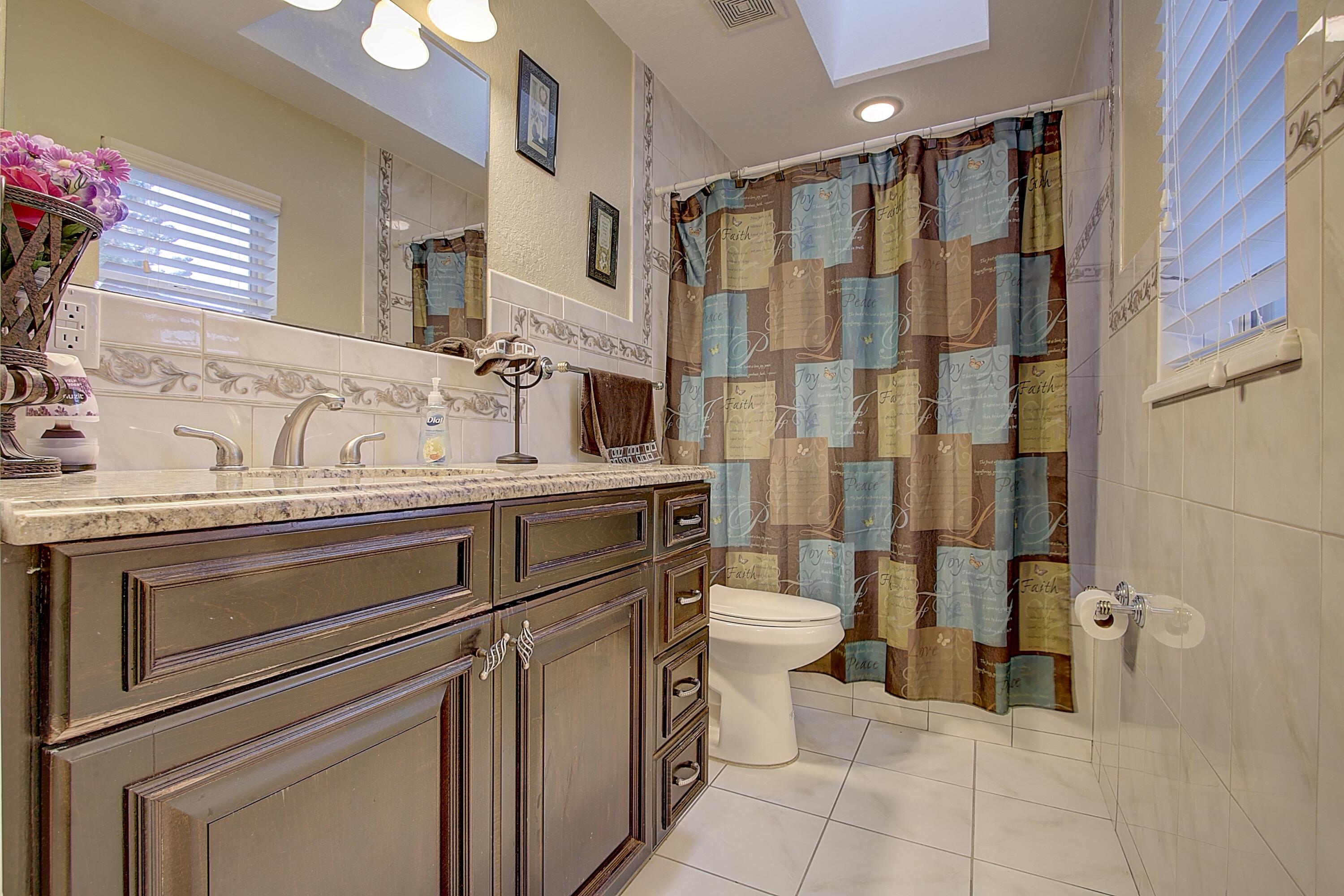 669 Howard Street Fort Pierce, FL 34982 - Photo 10 of 15 a bathroom with a sink toilet and shower