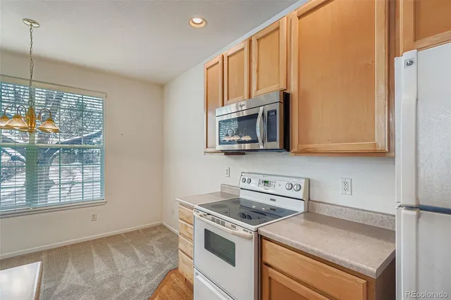 a kitchen with a sink stove and microwave