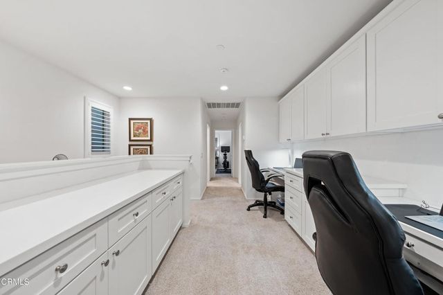 a spacious bedroom with a bed and a flat screen tv