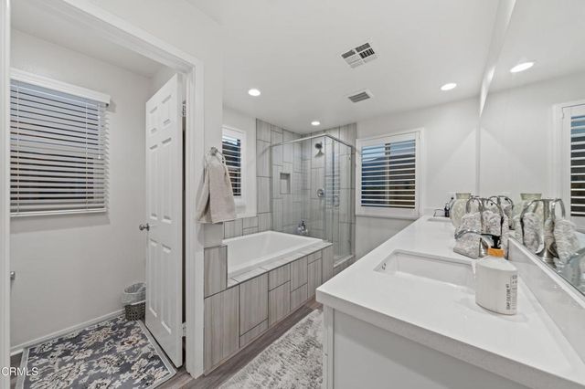 a view of walk in closet with clothes