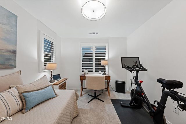 a bed sitting in a bedroom next to a window