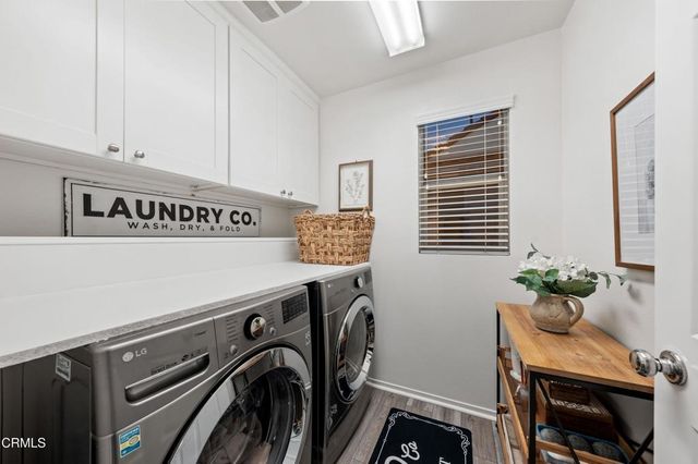 a en suite bathroom with a granite countertop toilet sink and mirror
