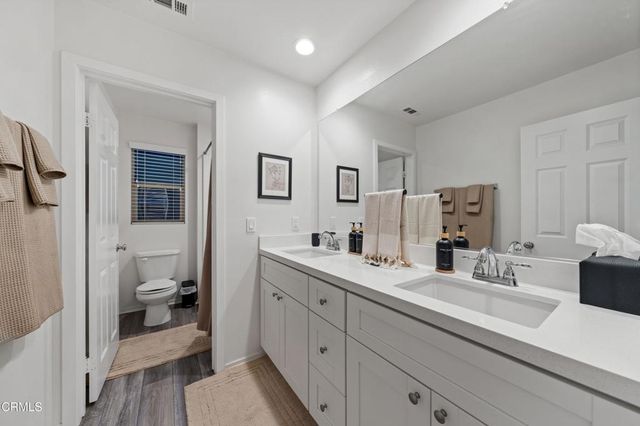a en suite bathroom with a double vanity sink mirror and shower