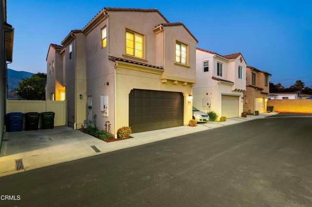 a living room with furniture a flat screen tv and a large window