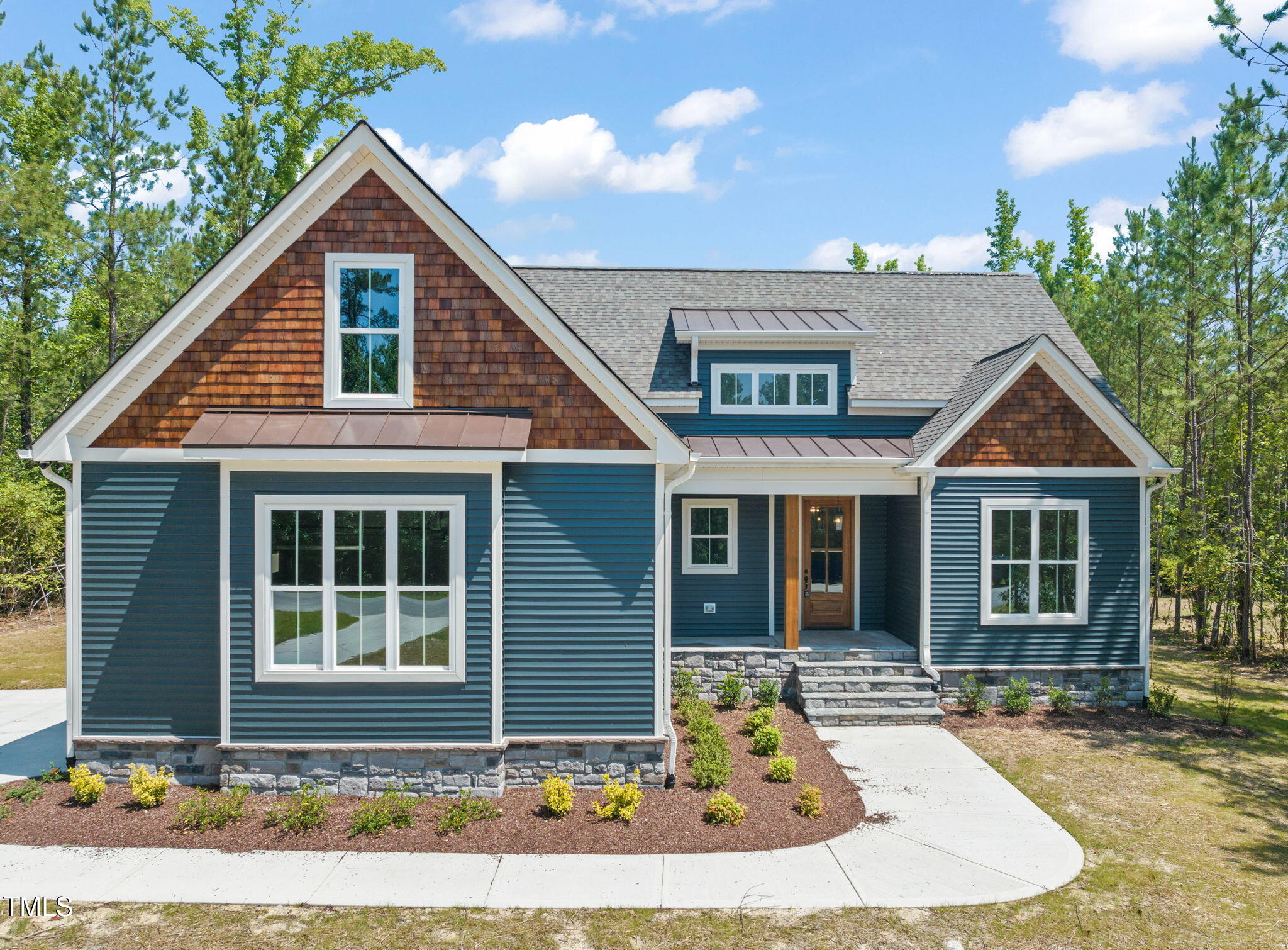 390 Pilot Ridge Road Zebulon, NC 27597 - Photo 1 of 41 a front view of a house with garden