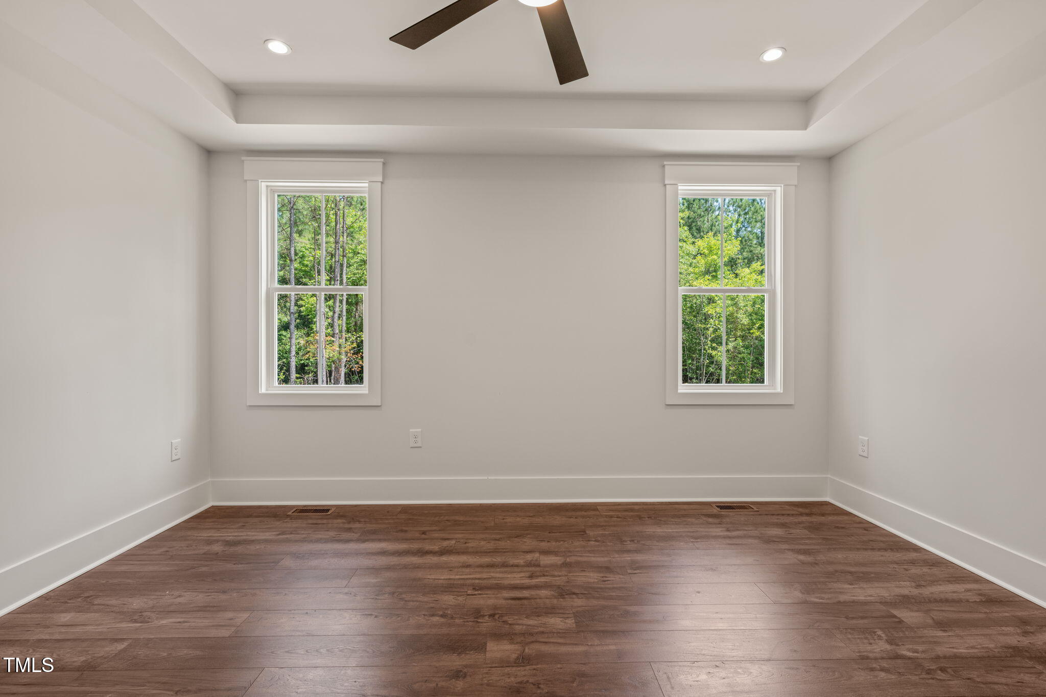 390 Pilot Ridge Road Zebulon, NC 27597 - Photo 18 of 41 an empty room with wooden floor and windows