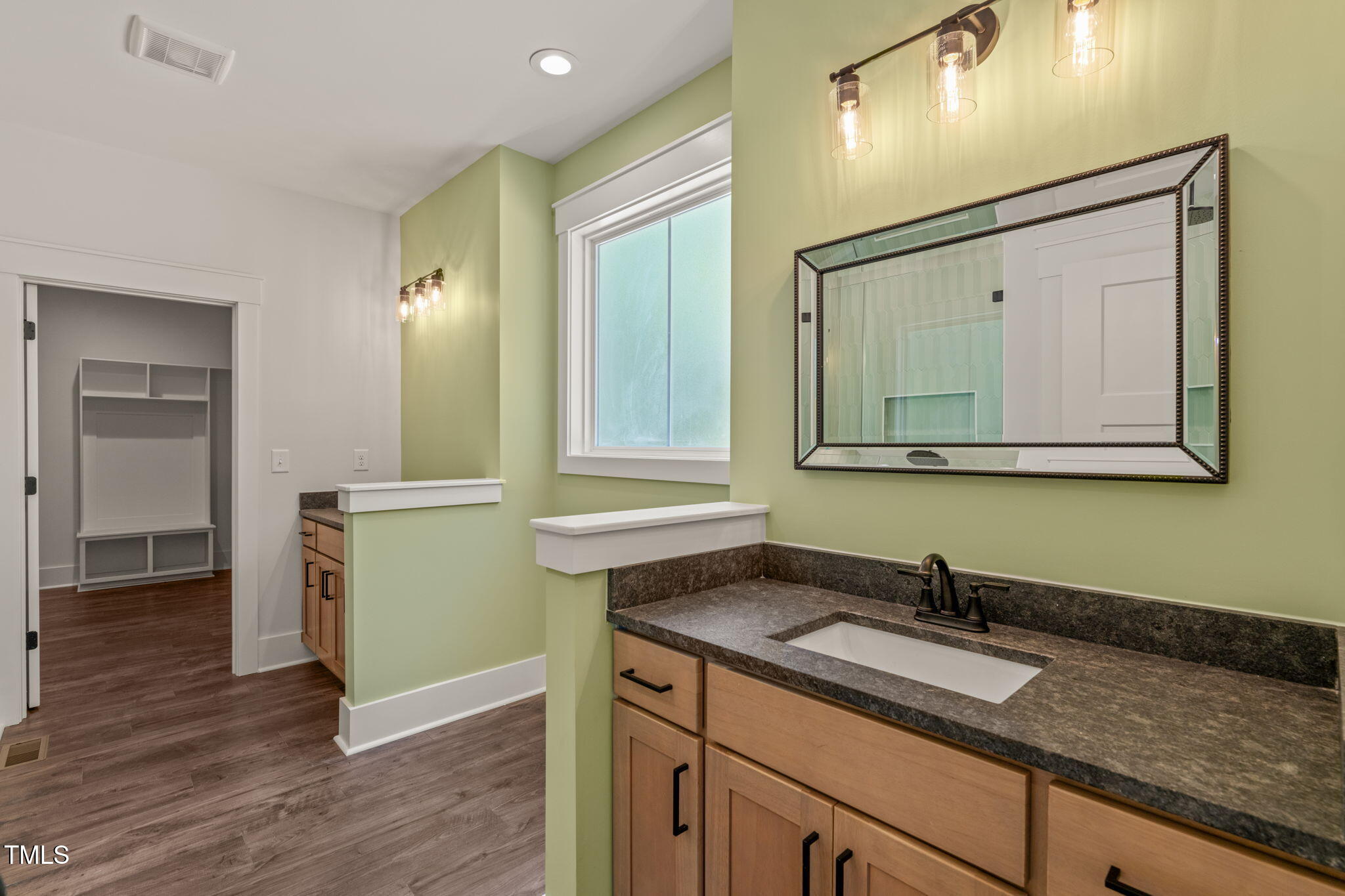 390 Pilot Ridge Road Zebulon, NC 27597 - Photo 19 of 41 a bathroom with a granite countertop sink and a mirror