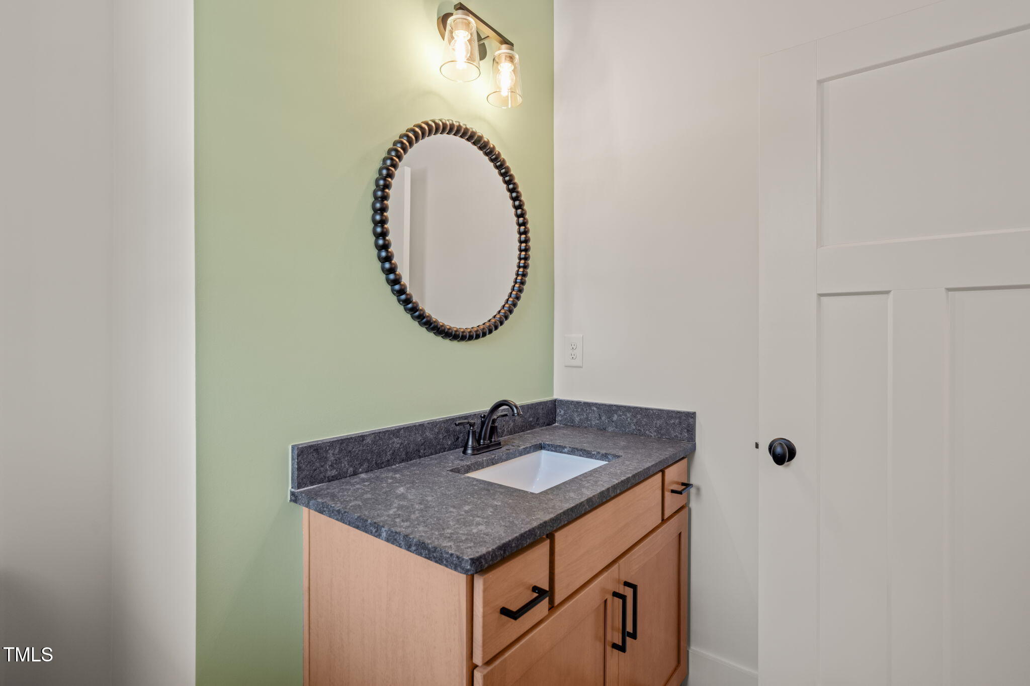390 Pilot Ridge Road Zebulon, NC 27597 - Photo 29 of 41 a bathroom with a sink and a mirror