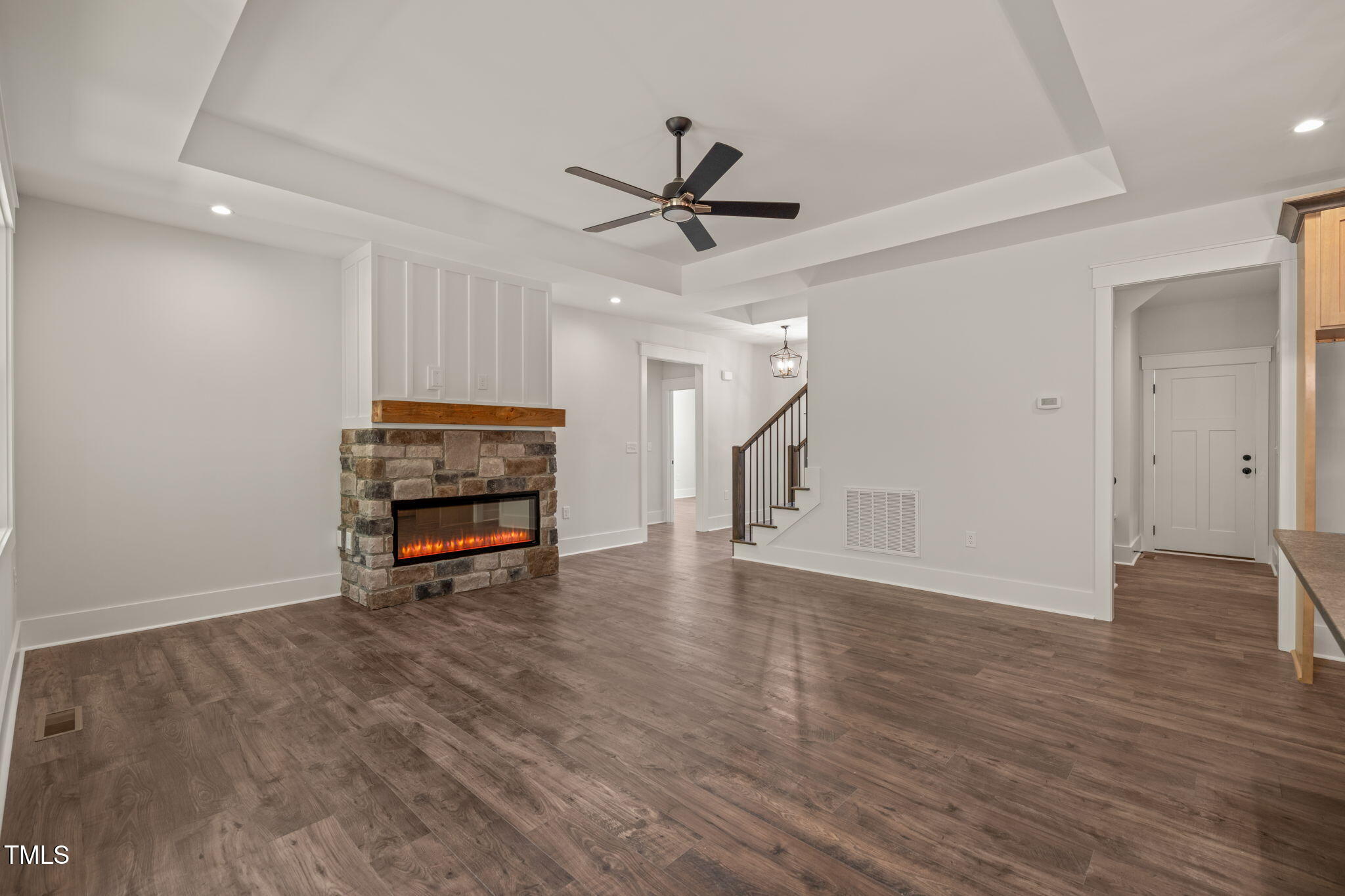 390 Pilot Ridge Road Zebulon, NC 27597 - Photo 5 of 41 an empty room with wooden floor ceiling fan and windows