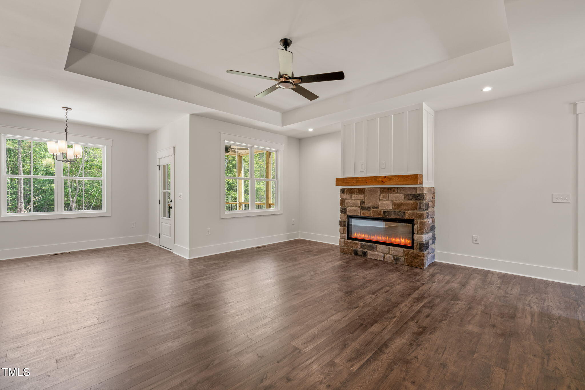 390 Pilot Ridge Road Zebulon, NC 27597 - Photo 6 of 41 a view of an empty room with a window and wooden floor
