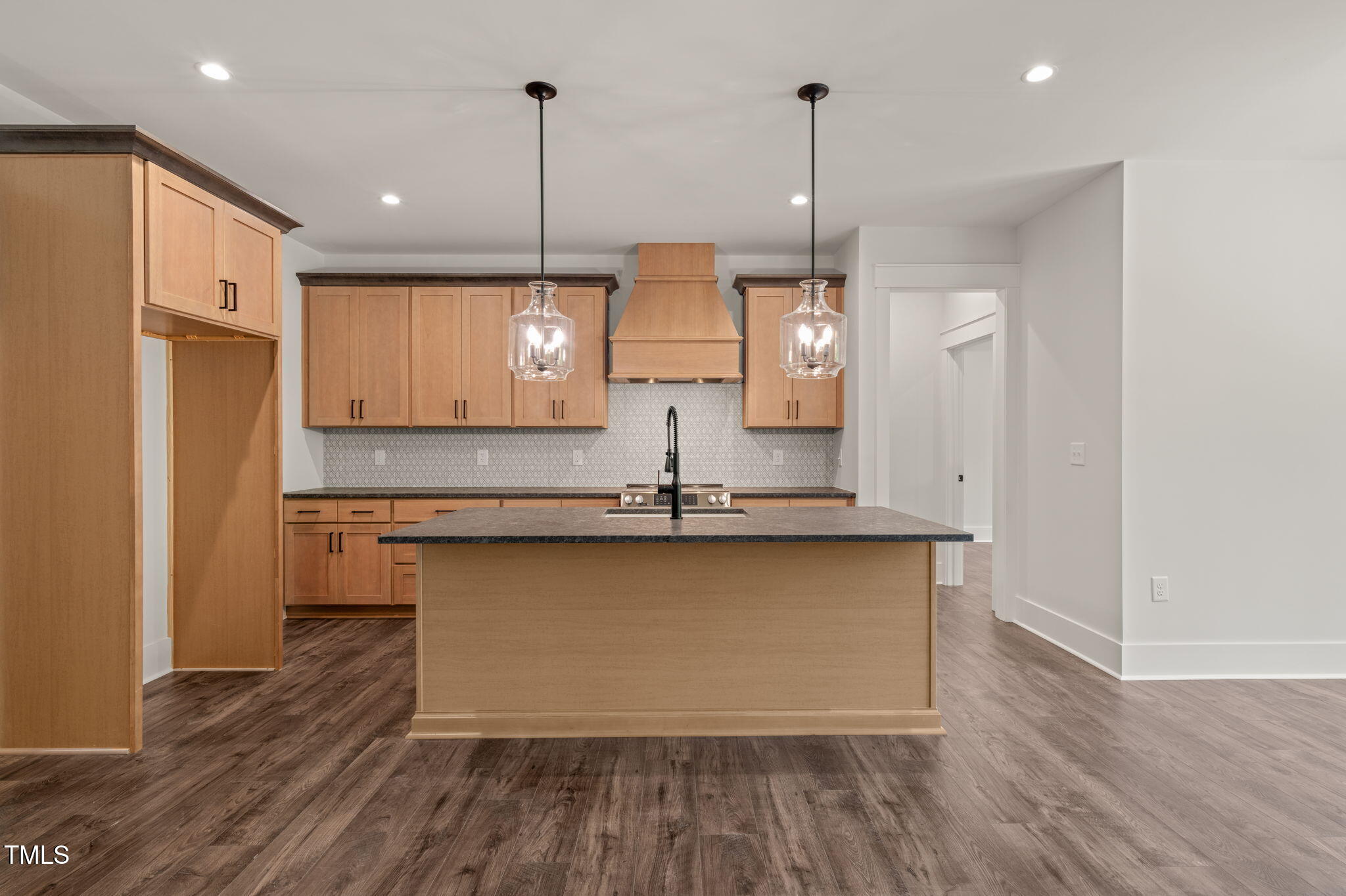 390 Pilot Ridge Road Zebulon, NC 27597 - Photo 8 of 41 a kitchen with stainless steel appliances granite countertop a sink a refrigerator a stove and white cabinets with wooden floor
