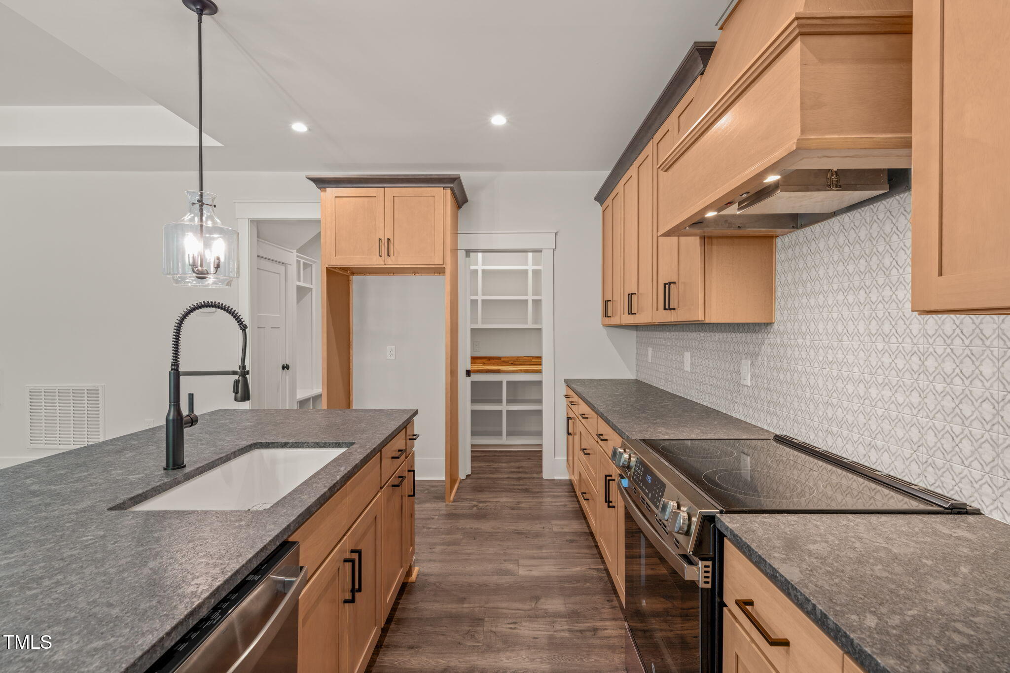 390 Pilot Ridge Road Zebulon, NC 27597 - Photo 10 of 41 a kitchen with stainless steel appliances granite countertop a sink a stove and a wooden floors
