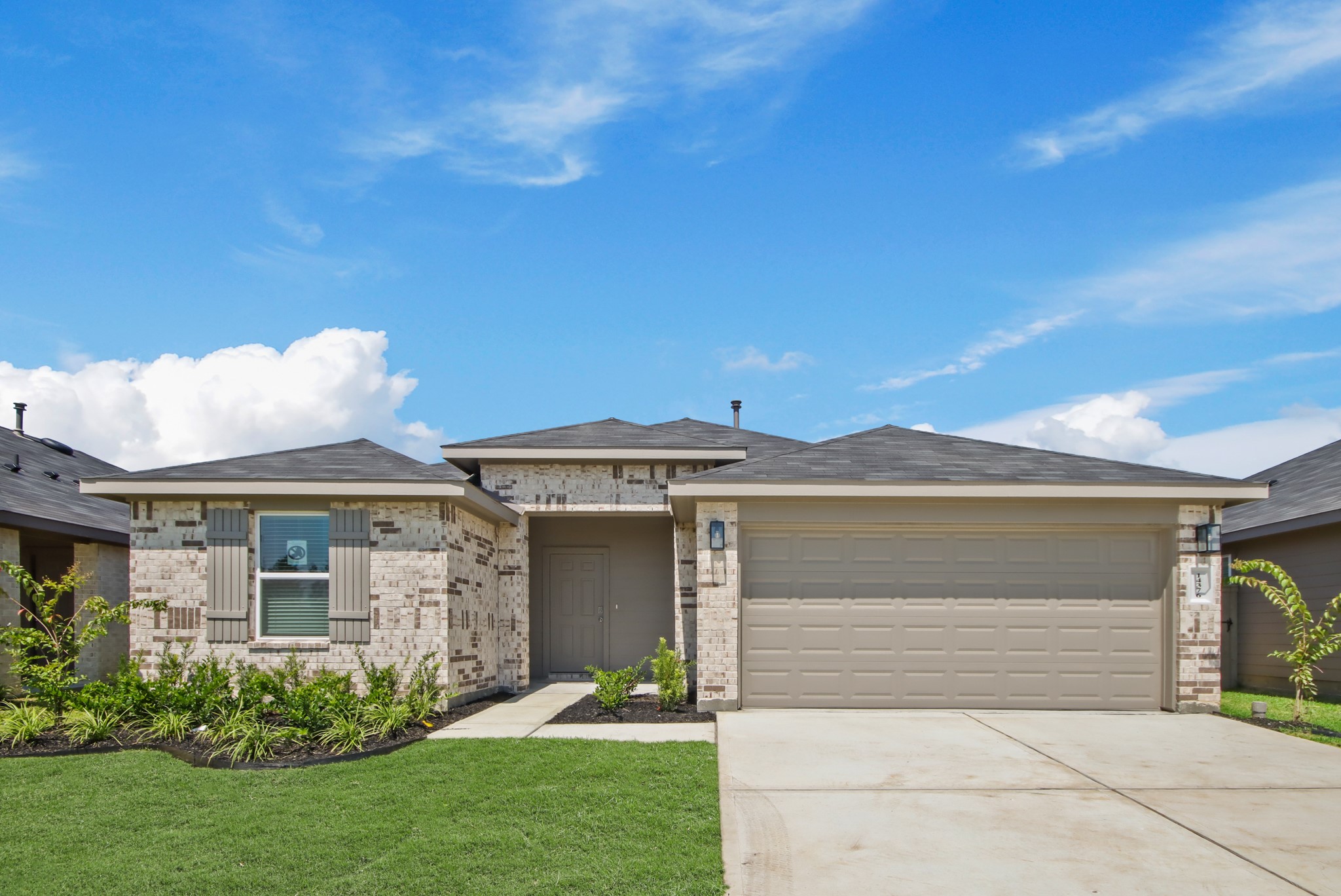 a front view of a house with a garden
