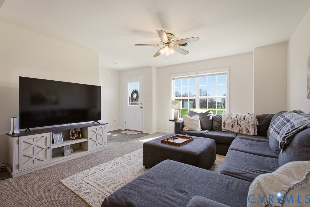 18262 Seals Road Bowling Green, VA 22427 - Photo 20 of 50 a living room with furniture and a flat screen tv