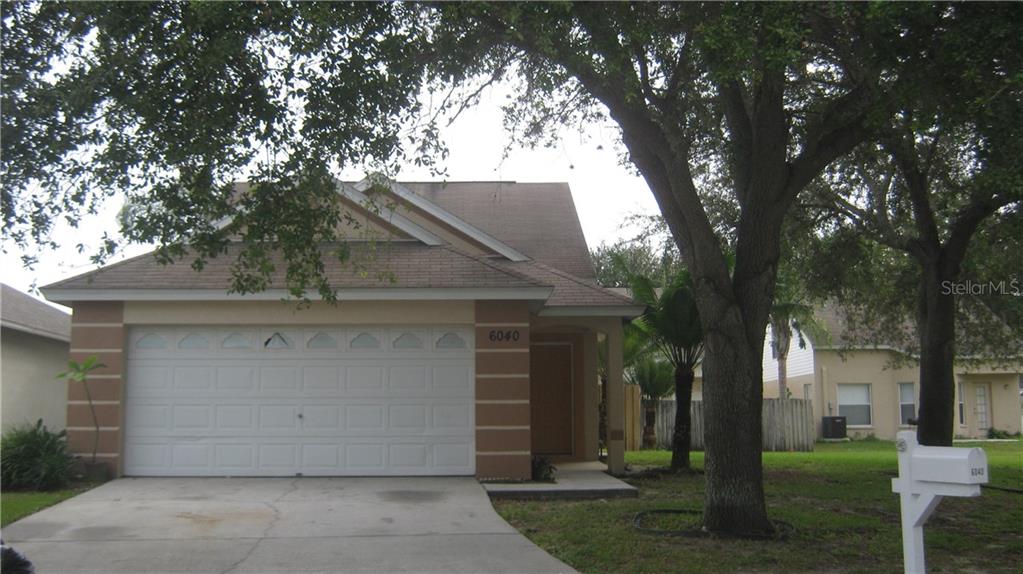 6040 Sand Key Lane Wesley Chapel, FL 33545 - Photo 1 of 1 front view of a house with a yard