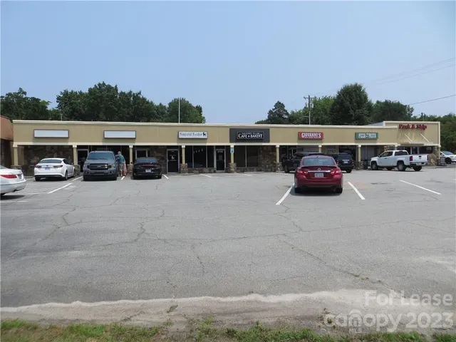 a view of city street with a car parked
