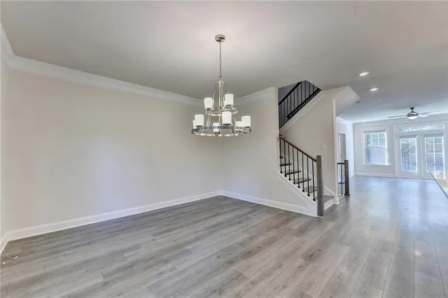 a view of a room with wooden floor chandelier and entryway
